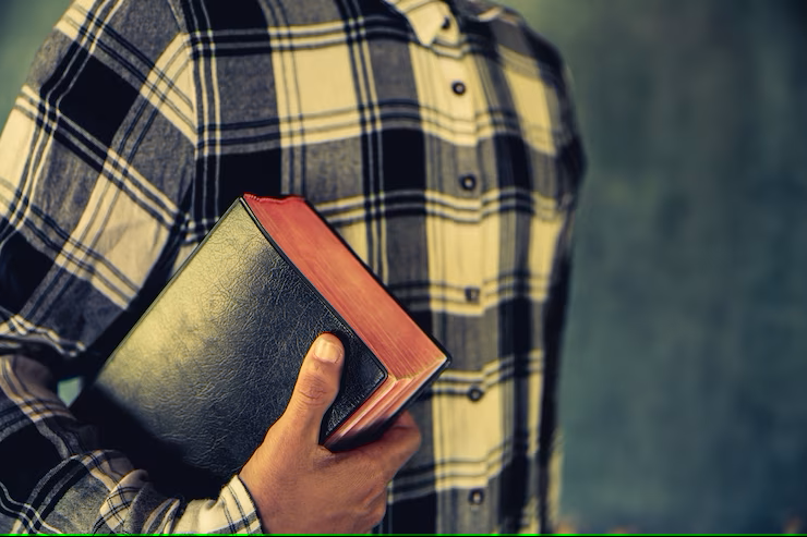young-man-holding-bible-his-hands
